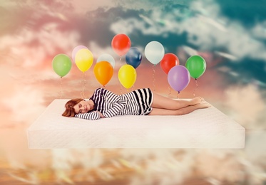 Sweet dreams. Bright cloudy sky with air balloons around sleeping woman 