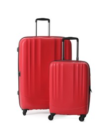 Red suitcases for travelling on white background