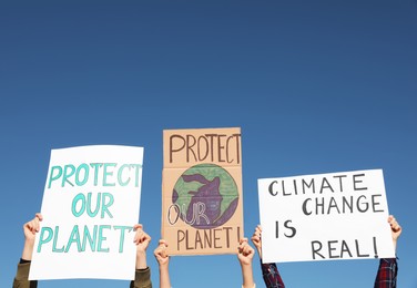 Photo of Group of people with posters protesting against climate change outdoors, closeup