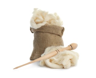 Soft wool in sack and spindle on white background