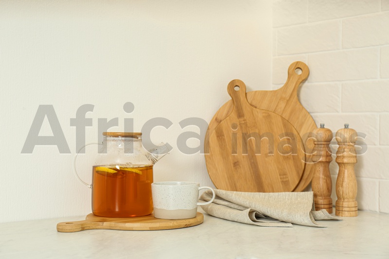 Photo of Teapot and different kitchen items on countertop indoors