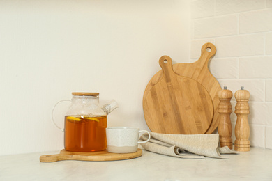 Teapot and different kitchen items on countertop indoors