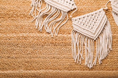 Large macrame on wicker straw background, flat lay. Space for text