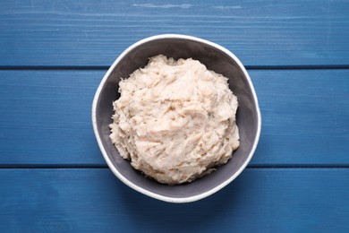 Photo of Delicious lard spread on blue wooden table, top view