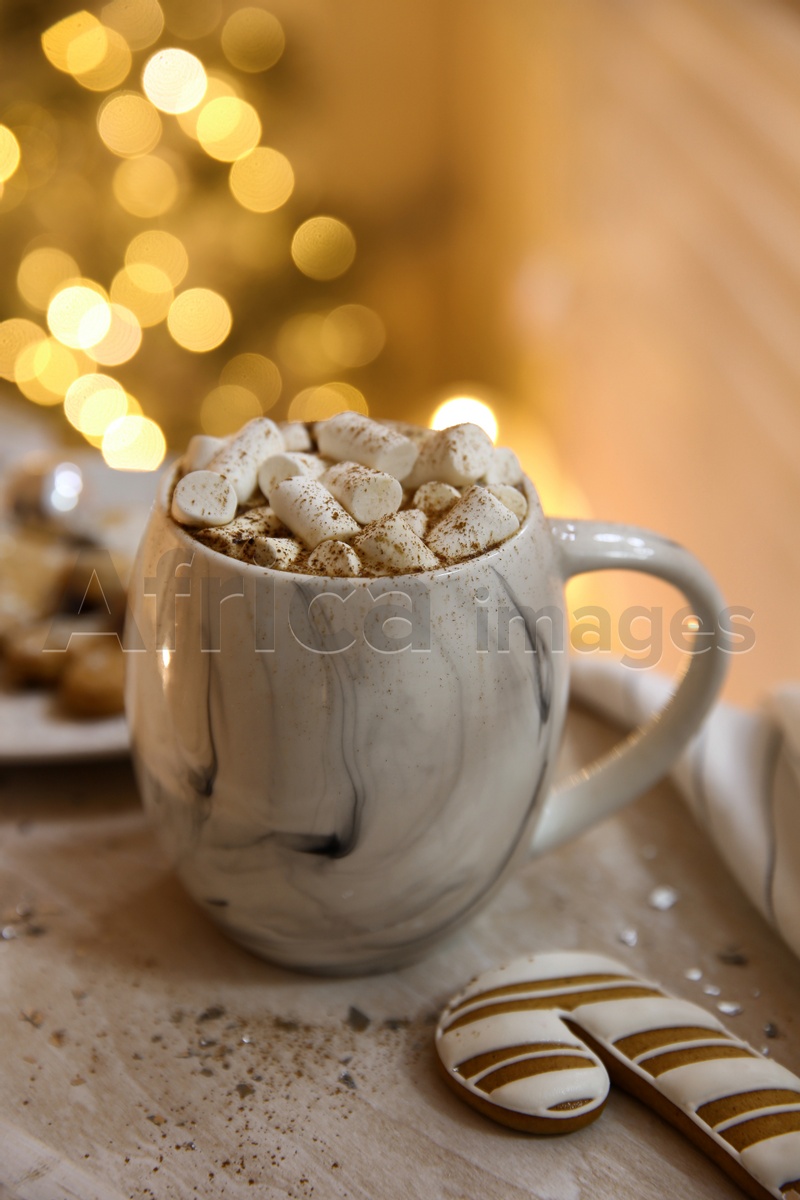 Tasty hot drink with marshmallows on table. Christmas atmosphere