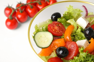 Tasty fresh Greek salad on white table, closeup