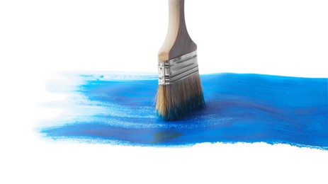 Photo of Blue paint stroke and brush on white background