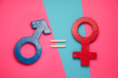 Photo of Gender equality. Equal sign, male and female symbols on color background, flat lay