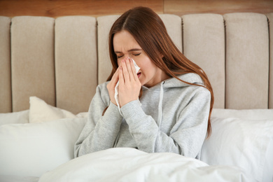 Sick young woman in bed at home. Influenza virus