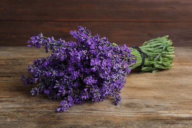 Photo of Beautiful fresh lavender bouquet on wooden table