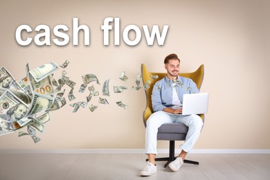 Cash Flow concept. Young man with laptop in armchair near beige wall and flying money