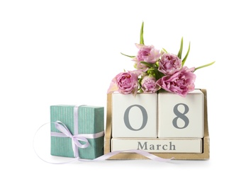 Wooden block calendar with date 8th of March, gift and tulips on white background. International Women's Day