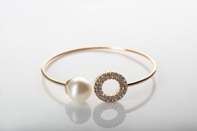 Elegant golden bracelet with pearl isolated on white