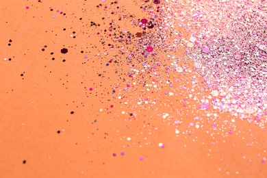 Shiny bright pink glitter on coral background