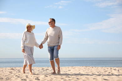 Mature couple spending time together on sea beach