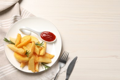 Photo of Plate with tasty baked potato wedges, rosemary and sauce on white wooden table, flat lay. Space for text