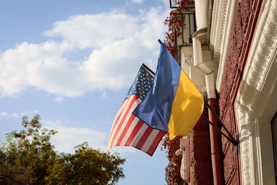 Flags of Ukraine and USA on building facade