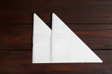 Clean napkins on wooden table, flat lay