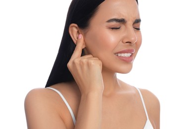 Photo of Young woman suffering from ear pain on white background, closeup