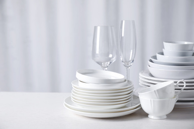 Set of clean dishware on white table