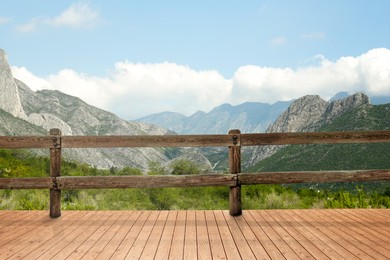 Image of Outdoor wooden terrace revealing picturesque view on mountains