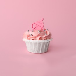 Photo of Baby shower cupcake with topper on pink background