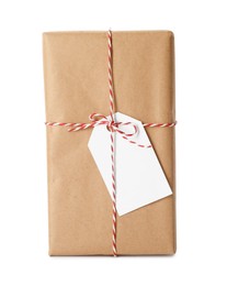 Gift box wrapped in kraft paper with bow and tag isolated on white