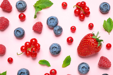 Different fresh berries on pink background, flat lay