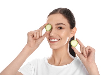 Photo of Happy young woman with cucumber slices on white background. Organic face mask