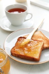 Breakfast with delicious orange marmalade on table