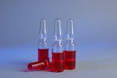 Pharmaceutical ampoules with medication on color background