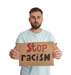 Young man holding sign with phrase Stop Racism on white background