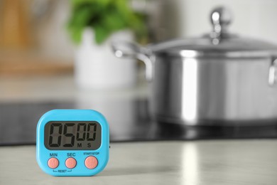 Digital kitchen timer on white table indoors. Space for text