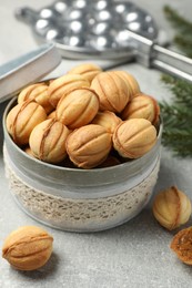 Photo of Delicious nut shaped cookies with boiled condensed milk on light grey table