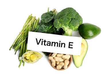Card with phrase Vitamin E and different products on white background, top view