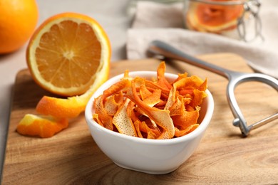 Photo of Dry orange peels and fresh fruit on white table