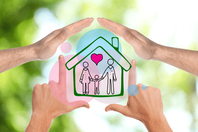 People forming house with their hands and illustration of family on blurred green background, closeup