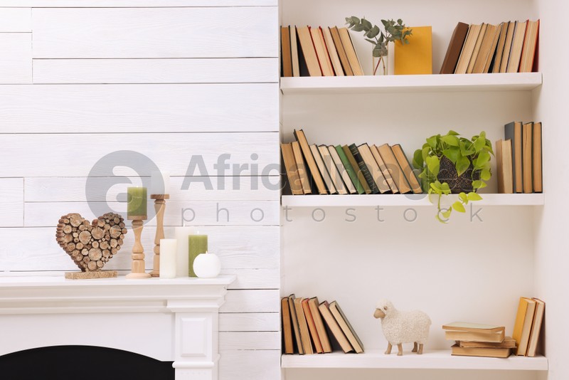 Collection of books and decor elements on shelves indoors