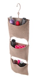 Stylish knitted organizer with toiletries and hair brushes on white background. Bath accessory
