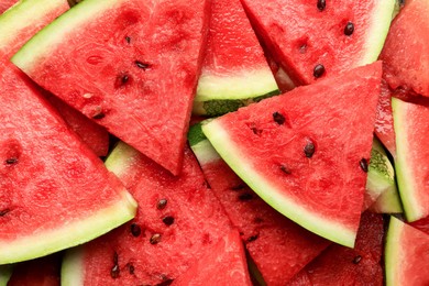 Slices of juicy ripe watermelon as background, top view
