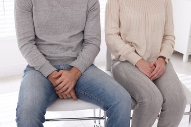 Photo of Couple waiting for appointment with STD specialist in clinic, closeup