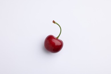 Photo of One ripe sweet cherry on white background