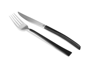 Photo of New fork and knife with black handles on white background