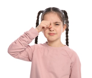 Little girl rubbing eye on white background. Annoying itch