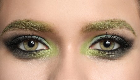 Young woman with evening makeup, closeup. Eye shadow product