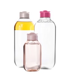 Bottles of micellar cleansing water on white background