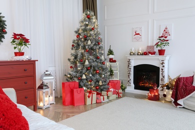 Living room with fireplace and Christmas decorations. Festive interior design
