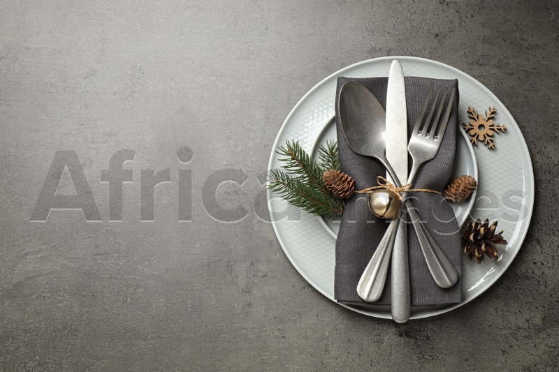 Beautiful Christmas table setting on grey background, top view. Space for text