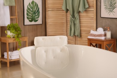 White tub with soft bath pillow indoors