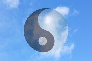 Ying Yang symbol against blue sky. Feng Shui philosophy